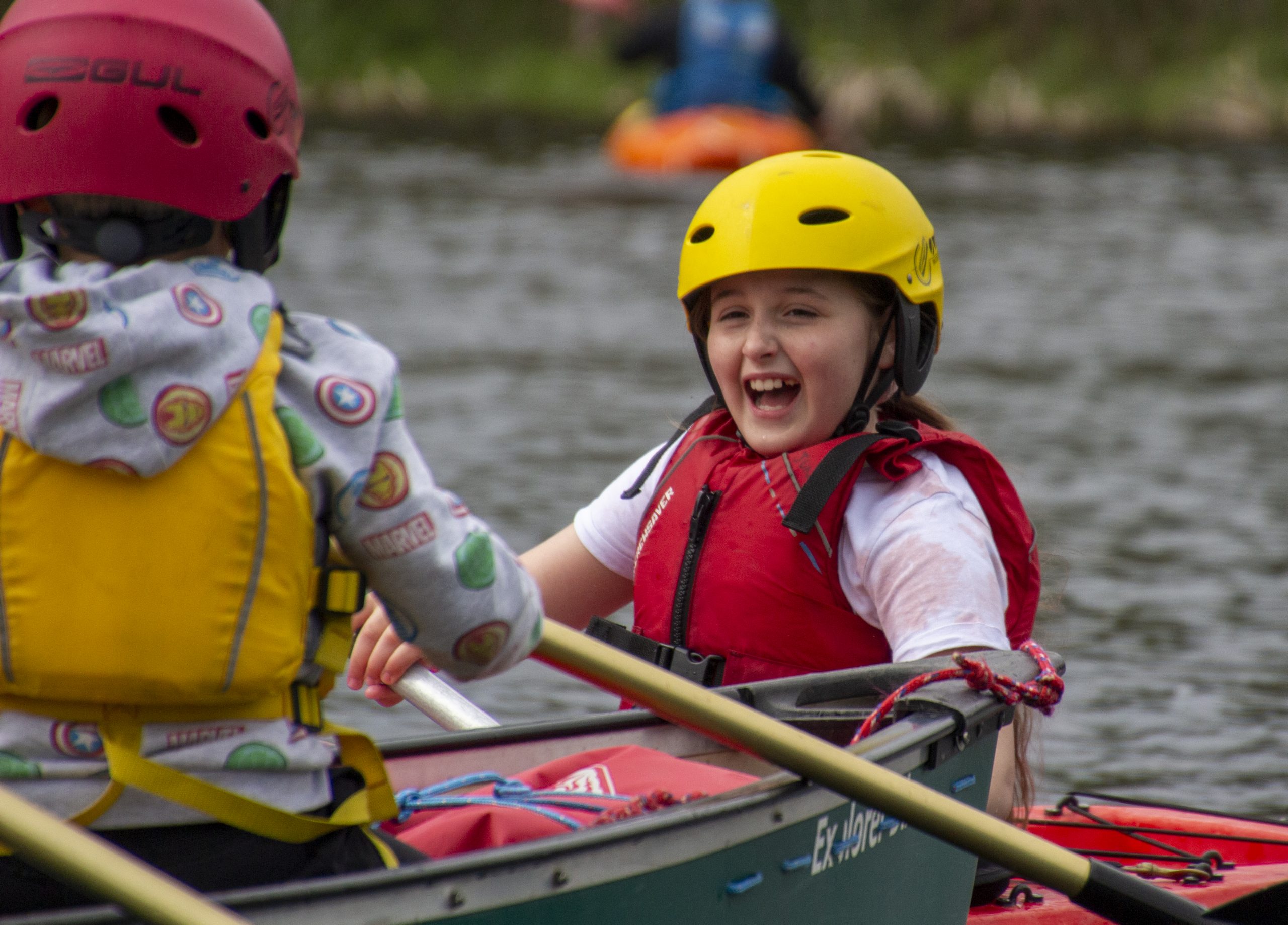 Female Cub Scout smiling in a canoe